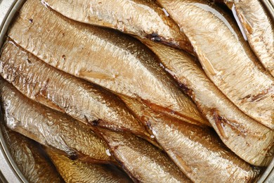 Photo of Canned sprats in oil as background, top view