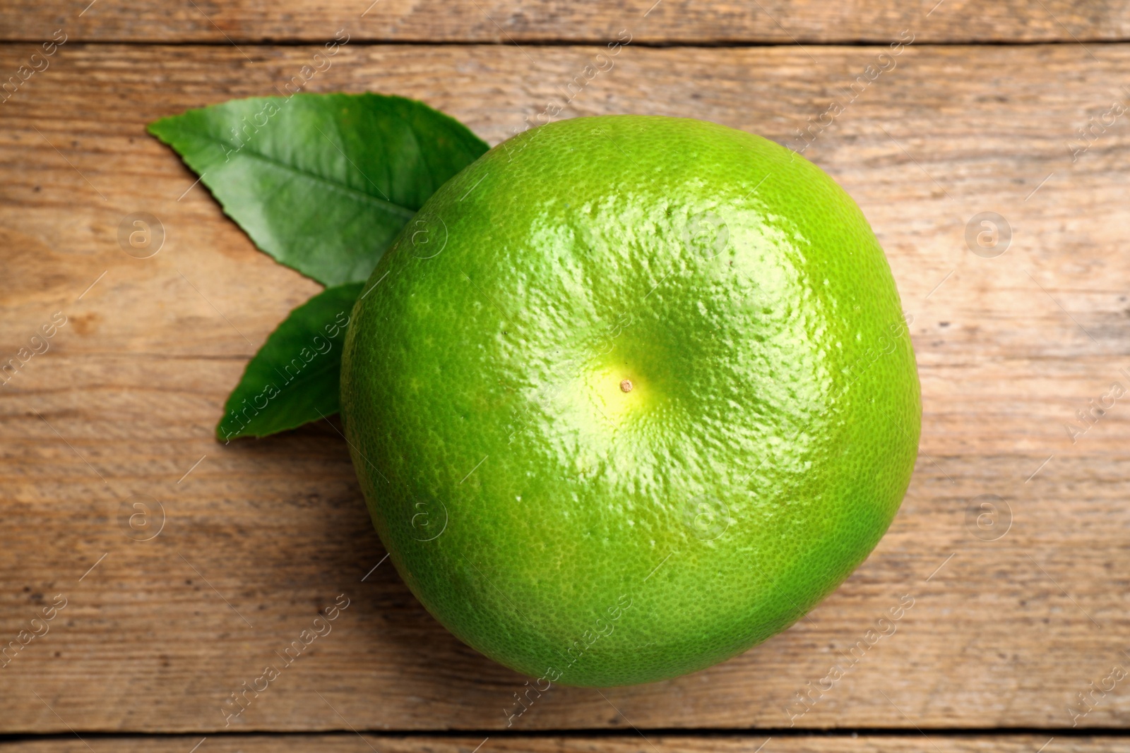 Photo of Fresh ripe sweetie fruit on wooden table, top view