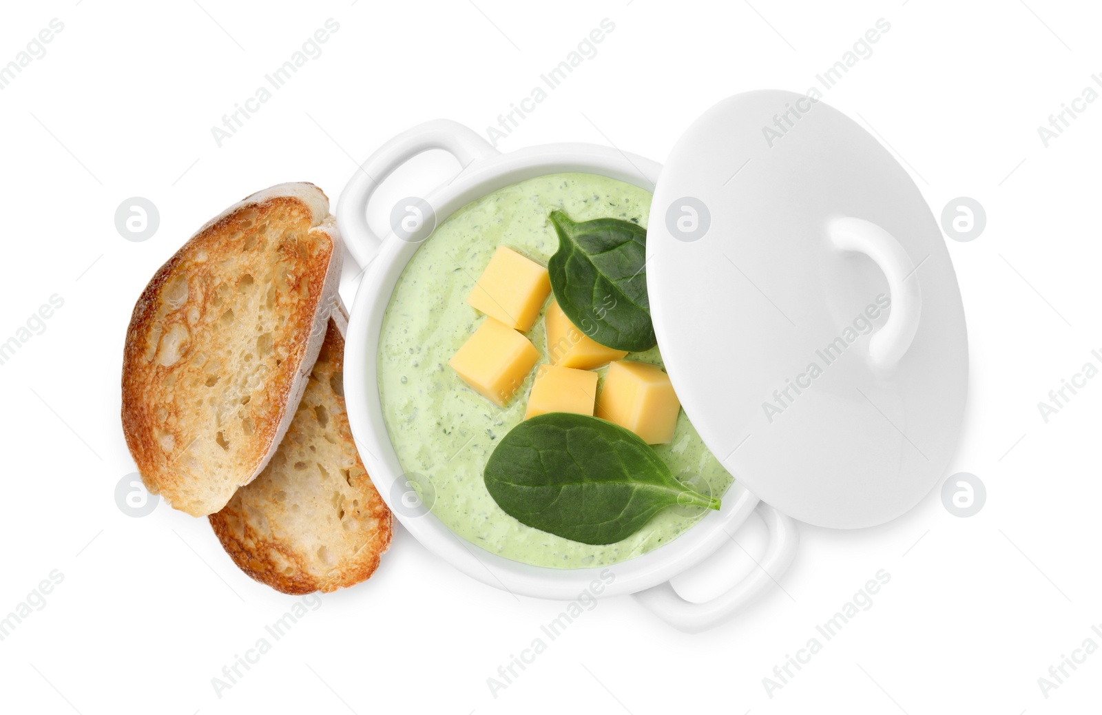 Photo of Delicious spinach cream soup with cheese in bowl isolated on white, top view