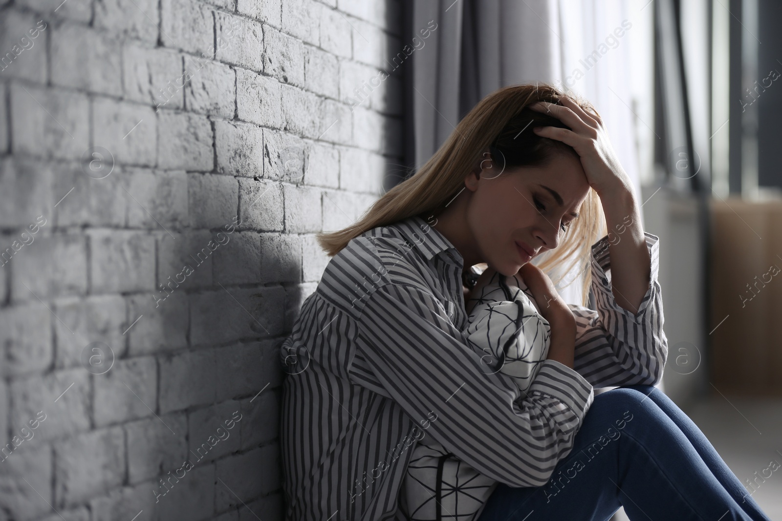 Photo of Lonely woman suffering from depression at home