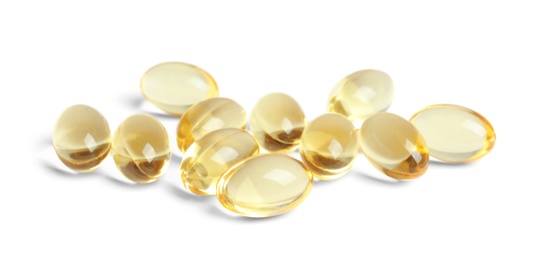 Photo of Cod liver oil pills on white background