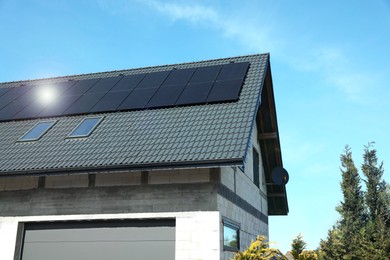 House with installed solar panels on roof. Alternative energy