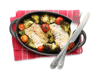 Photo of Tasty cod cooked with vegetables and cutlery isolated on white, top view
