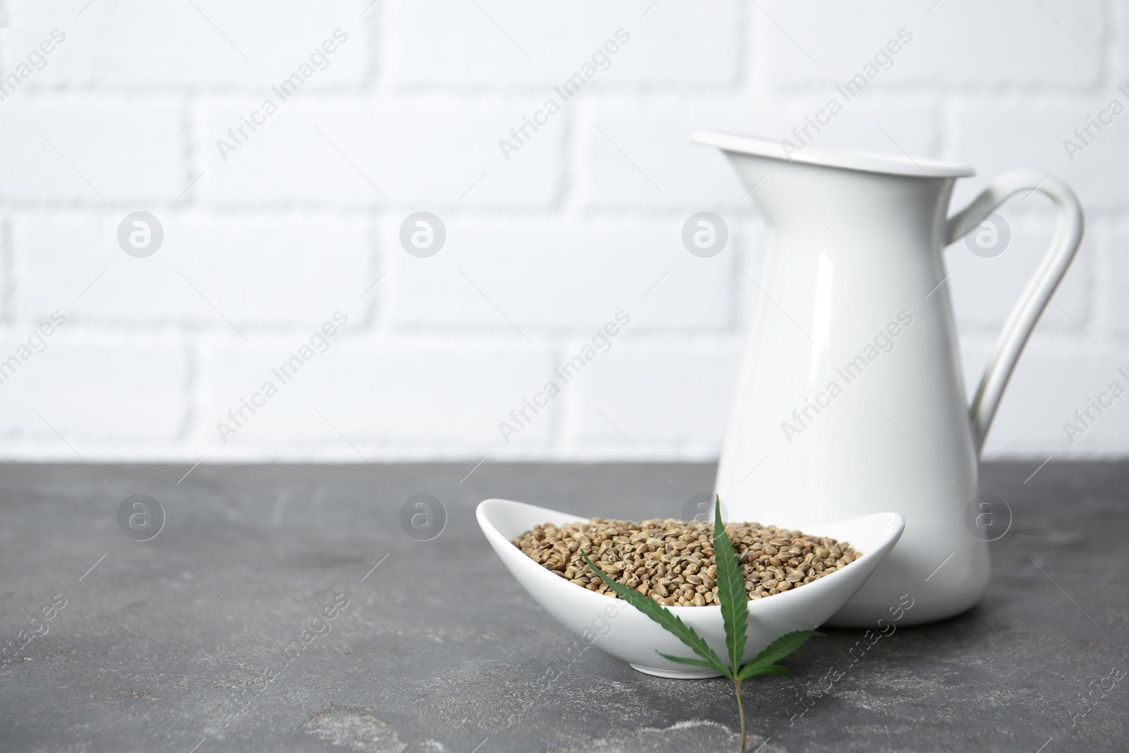 Photo of Composition with hemp seeds on grey table