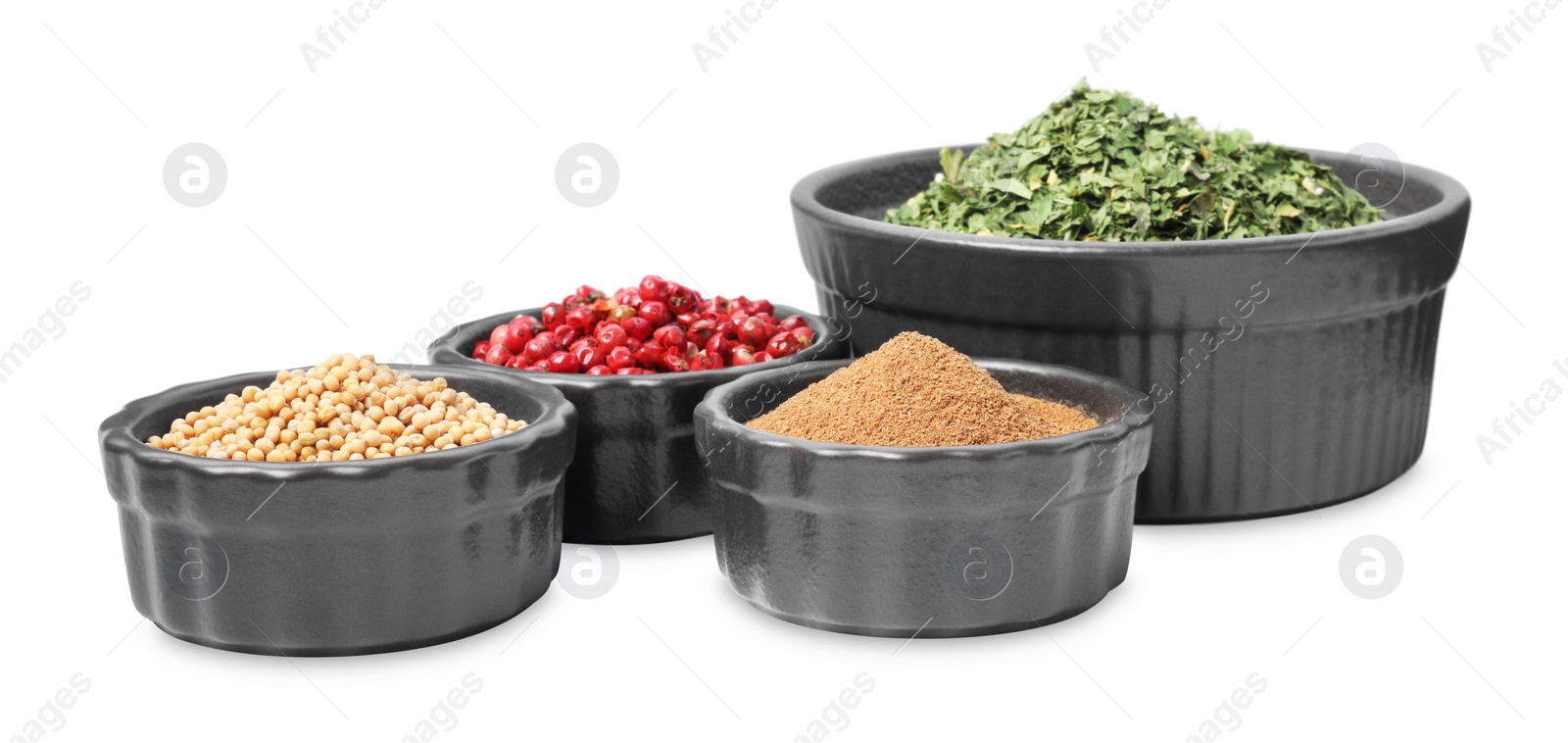 Photo of Bowls with different spices on white background