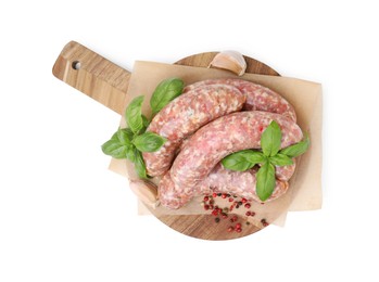 Photo of Wooden board with raw homemade sausages and different spices isolated on white, top view
