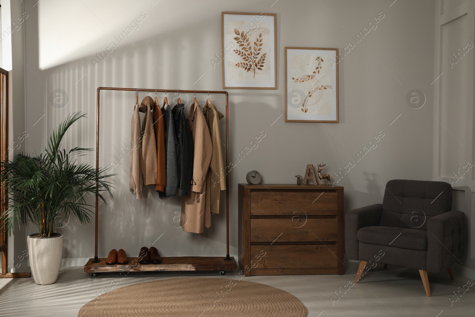 Photo of Modern dressing room interior with stylish clothes, shoes and decorative elements