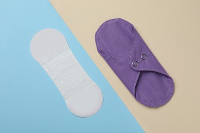 Photo of Pantyliner and reusable menstrual pad on color background, flat lay