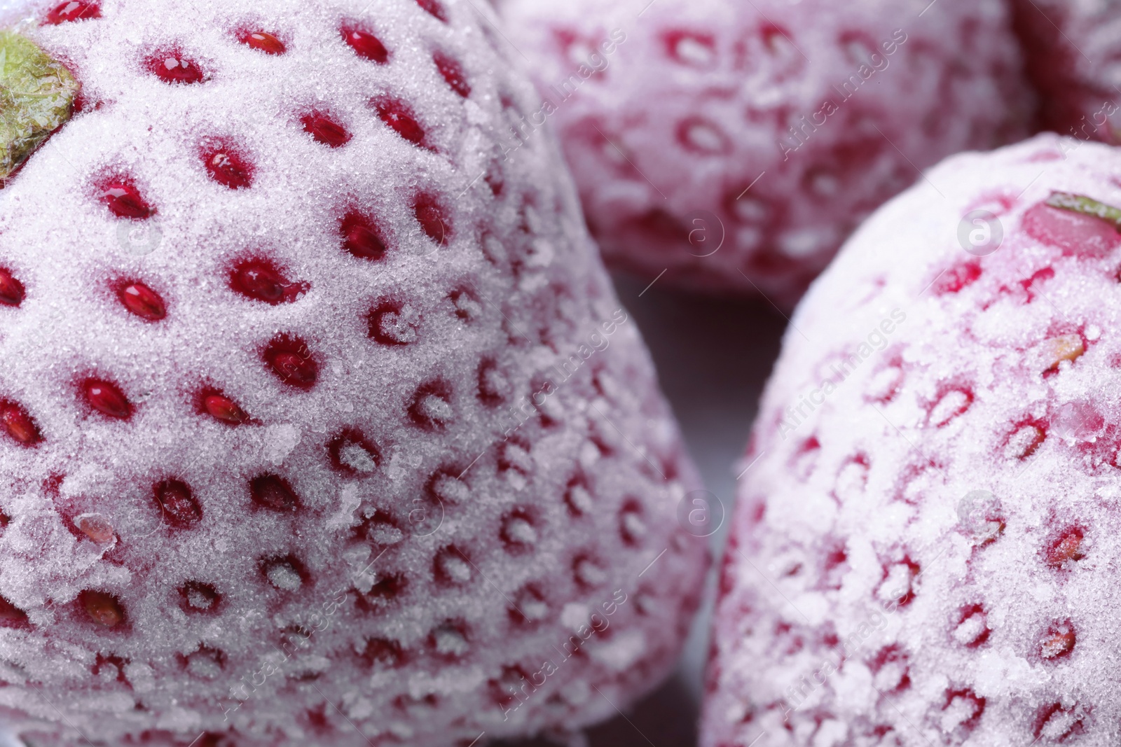 Photo of Frozen ripe strawberries on table, closeup view