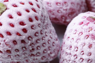 Frozen ripe strawberries on table, closeup view