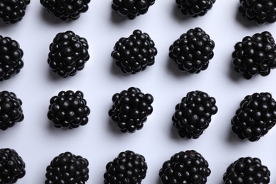 Tasty ripe blackberries on white background, flat lay