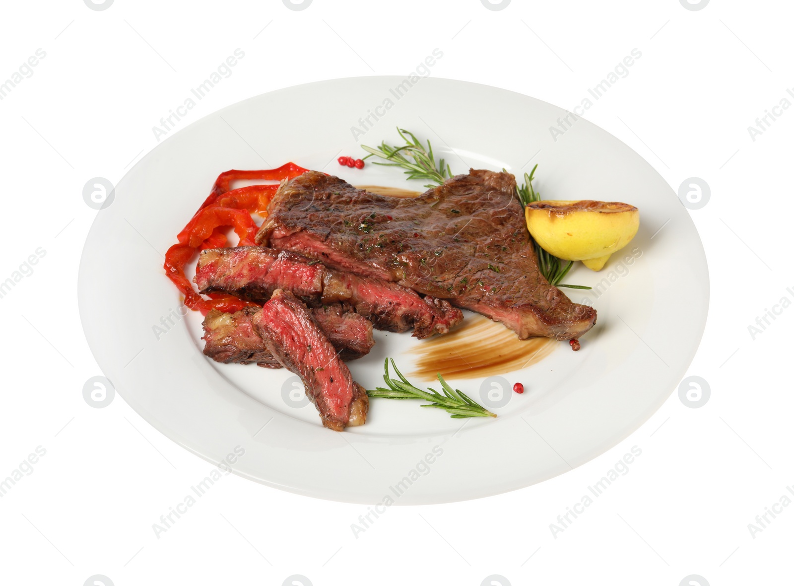 Photo of Delicious grilled beef steak with pepper, spices and lemon isolated on white