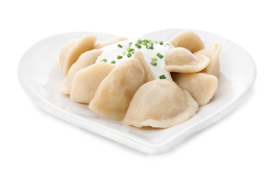 Photo of Delicious cooked dumplings with sour cream on white background