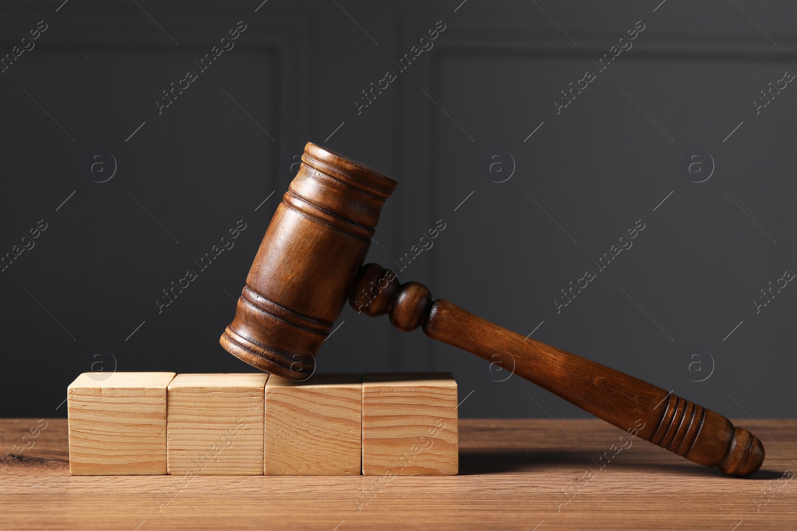 Photo of Law. Blank wooden cubes and gavel on table