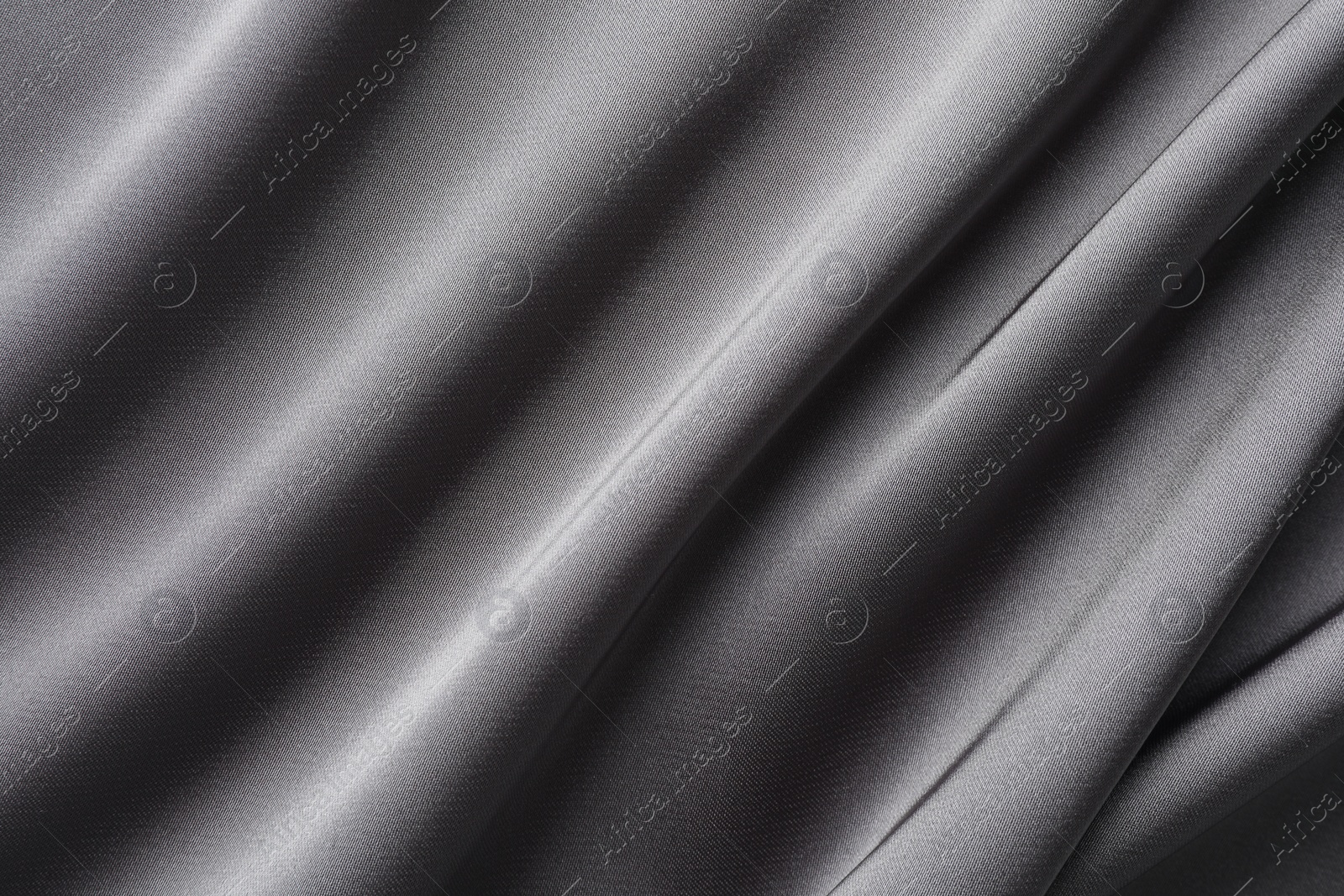 Photo of Texture of beautiful light grey silk fabric as background, closeup