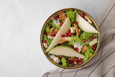 Delicious pear salad in bowl on light table, top view. Space for text