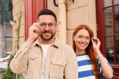 Portrait of happy couple in glasses outdoors
