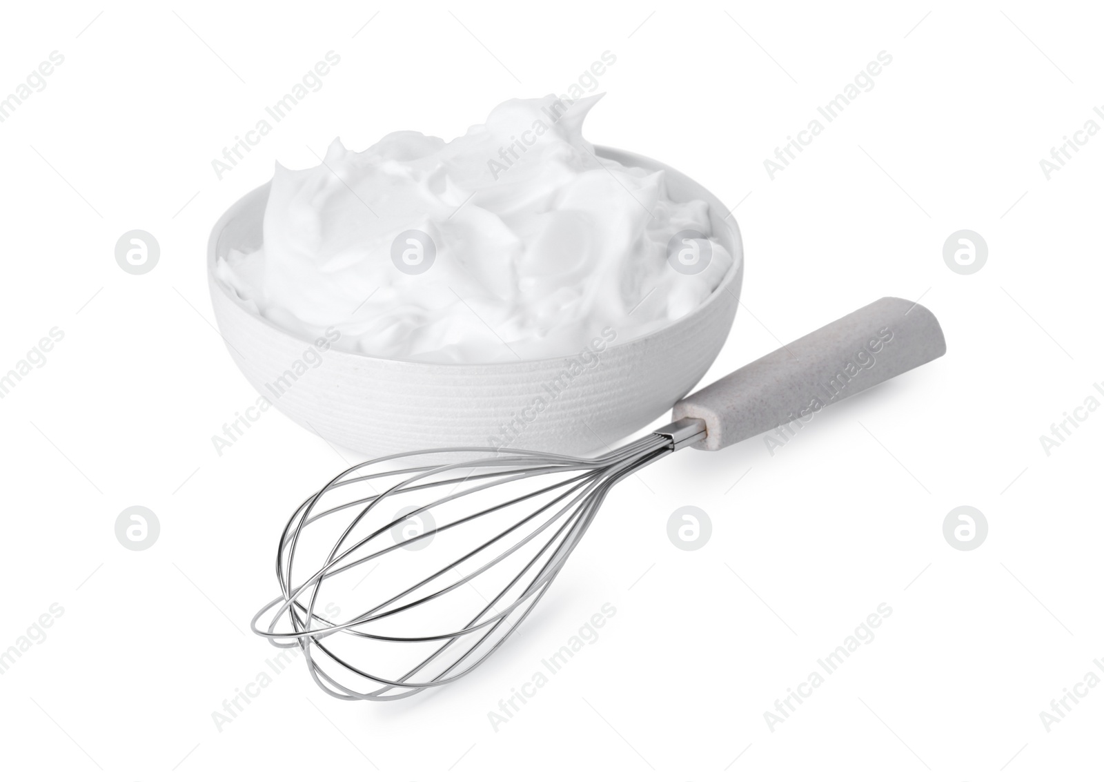 Photo of Bowl with whipped cream and whisk isolated on white