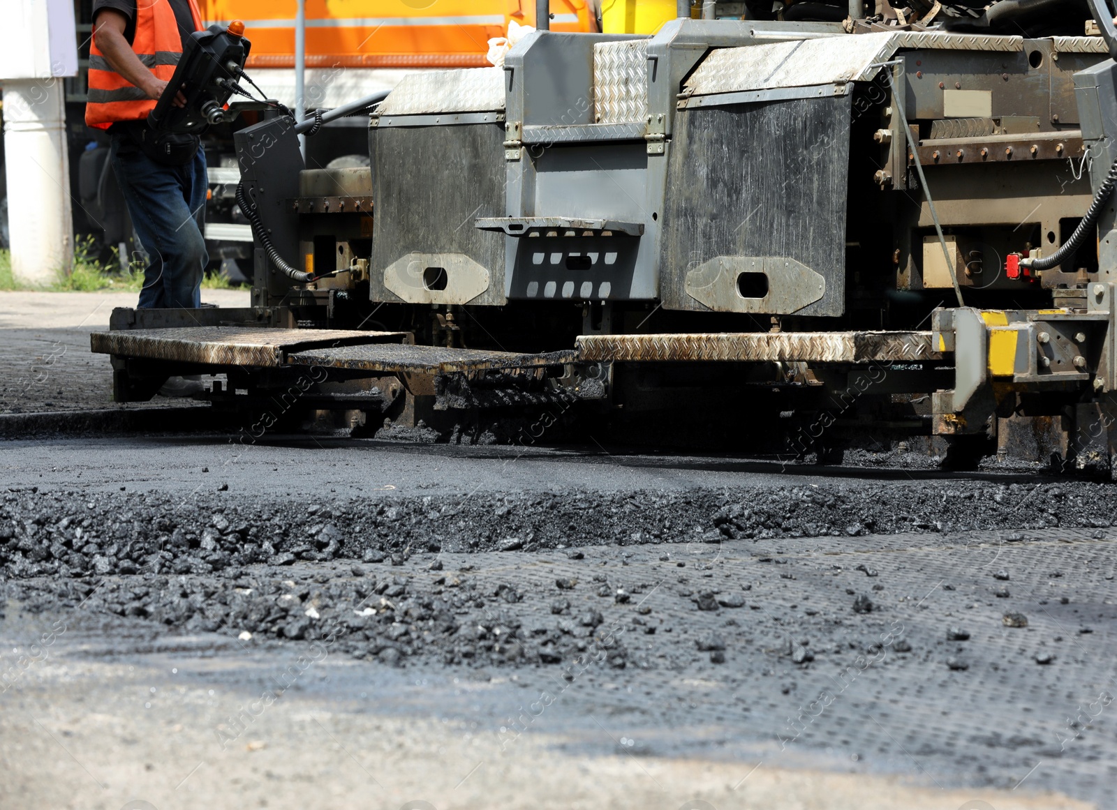 Photo of Road repair machinery working on street, closeup view