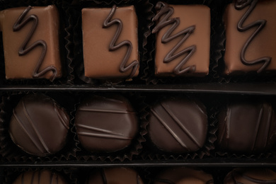 Many different chocolate candies in box, closeup