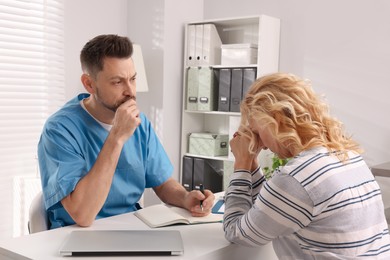 Doctor listening to patient's complaints during consultation in clinic