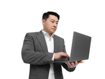 Businessman in suit working on laptop against white background