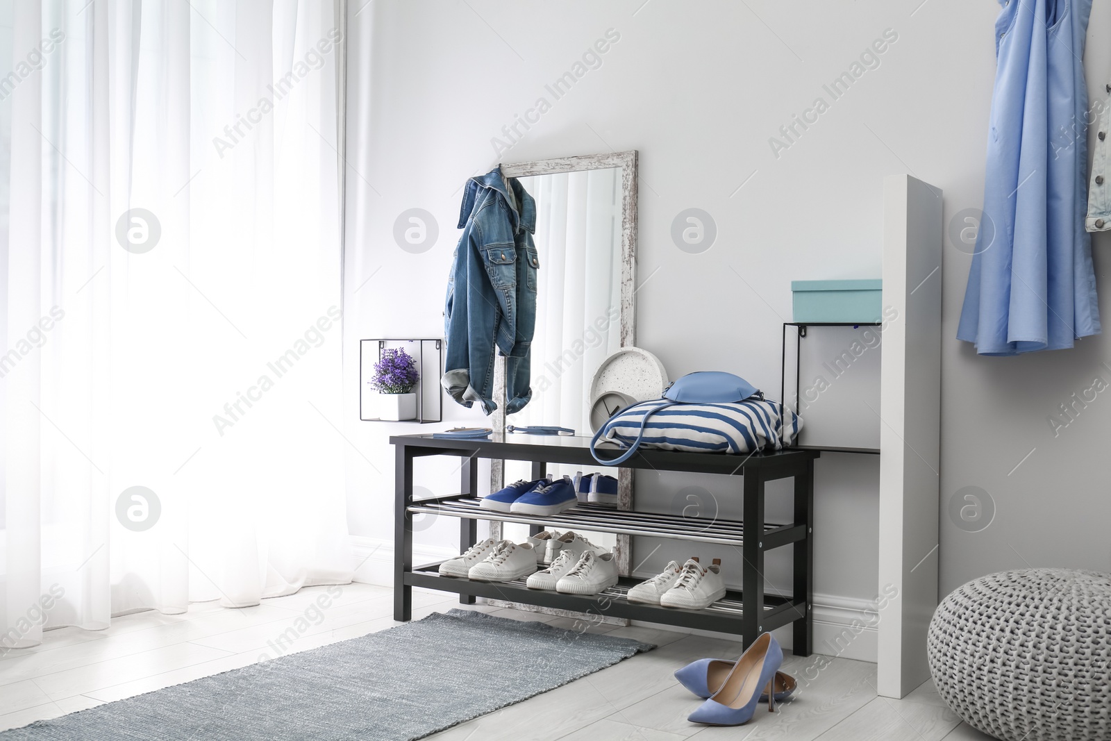 Cozy stylish hallway interior with shoe rack and mirror, space for text. Home design idea Photo of Cozy stylish hallway interior with shoe rack and mirror, space for text. Home design idea