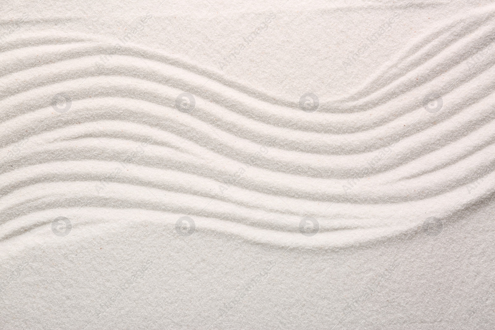 Photo of White sand with pattern as background, top view. Concept of zen and harmony