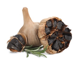 Photo of Fermented black garlic and rosemary isolated on white