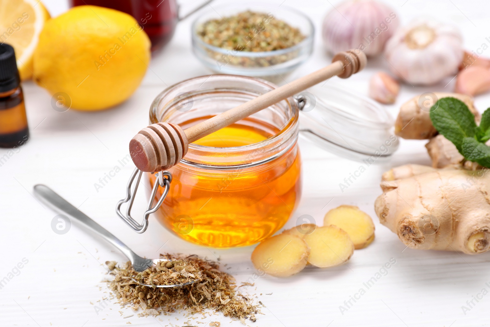 Photo of Different natural cold remedies on white wooden table. Cough treatment