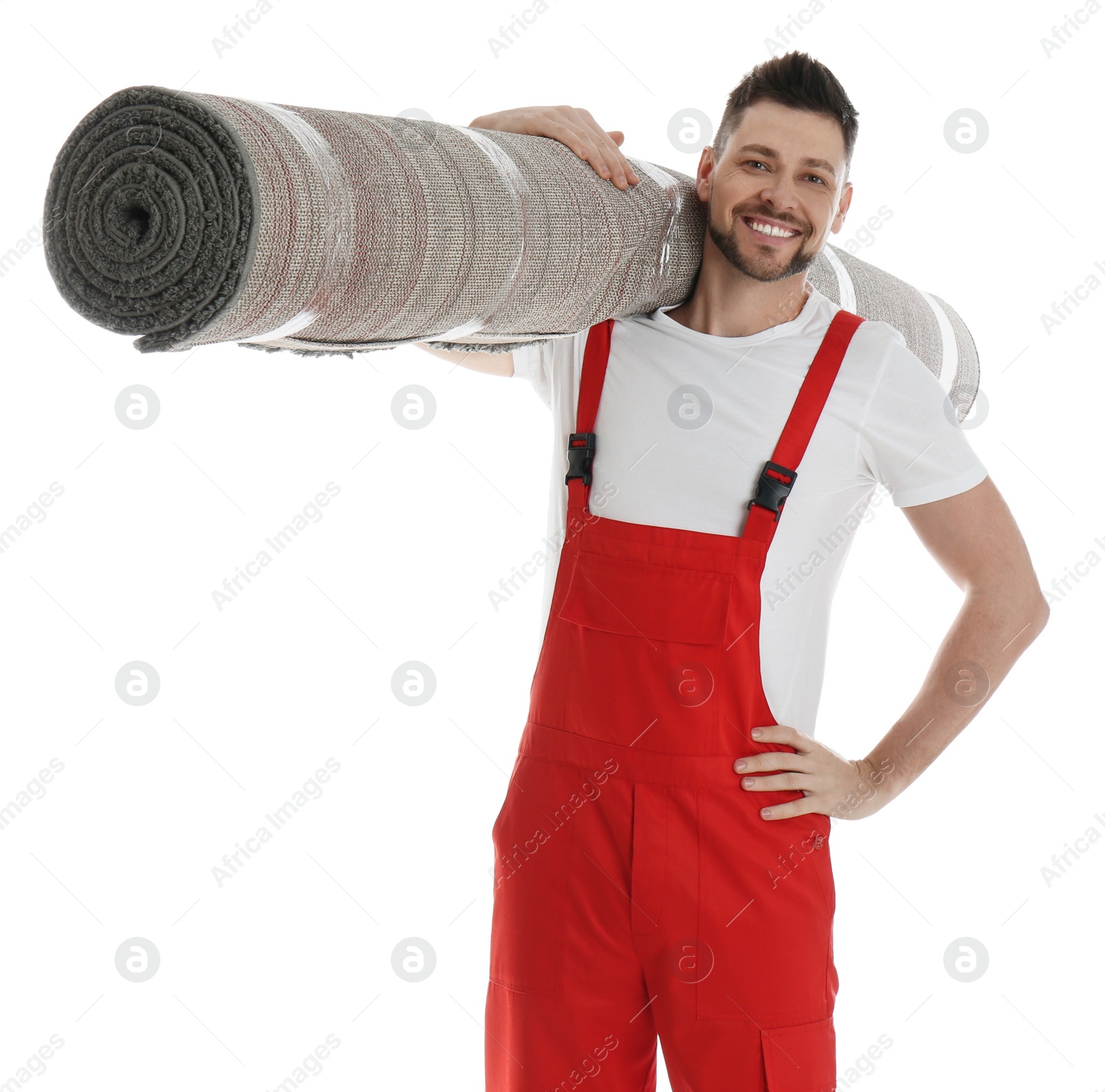 Photo of Male worker with rolled carpet on white background