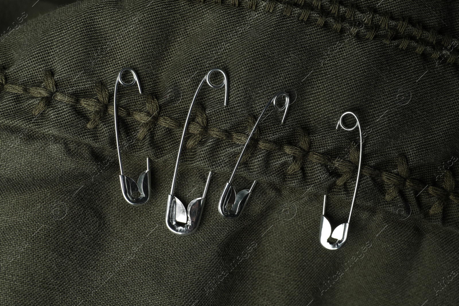 Photo of Top view of metal safety pins on clothing