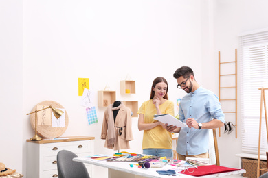 Fashion designers creating new clothes in studio