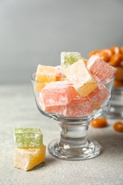 Dessert bowls filled with tasty sweets on light table