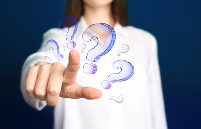 Image of Businesswoman on blue background touching drawing of question mark