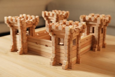 Photo of Wooden fortress on table indoors, closeup. Children's toy