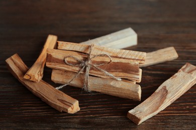 Photo of Palo santo sticks on wooden table, closeup