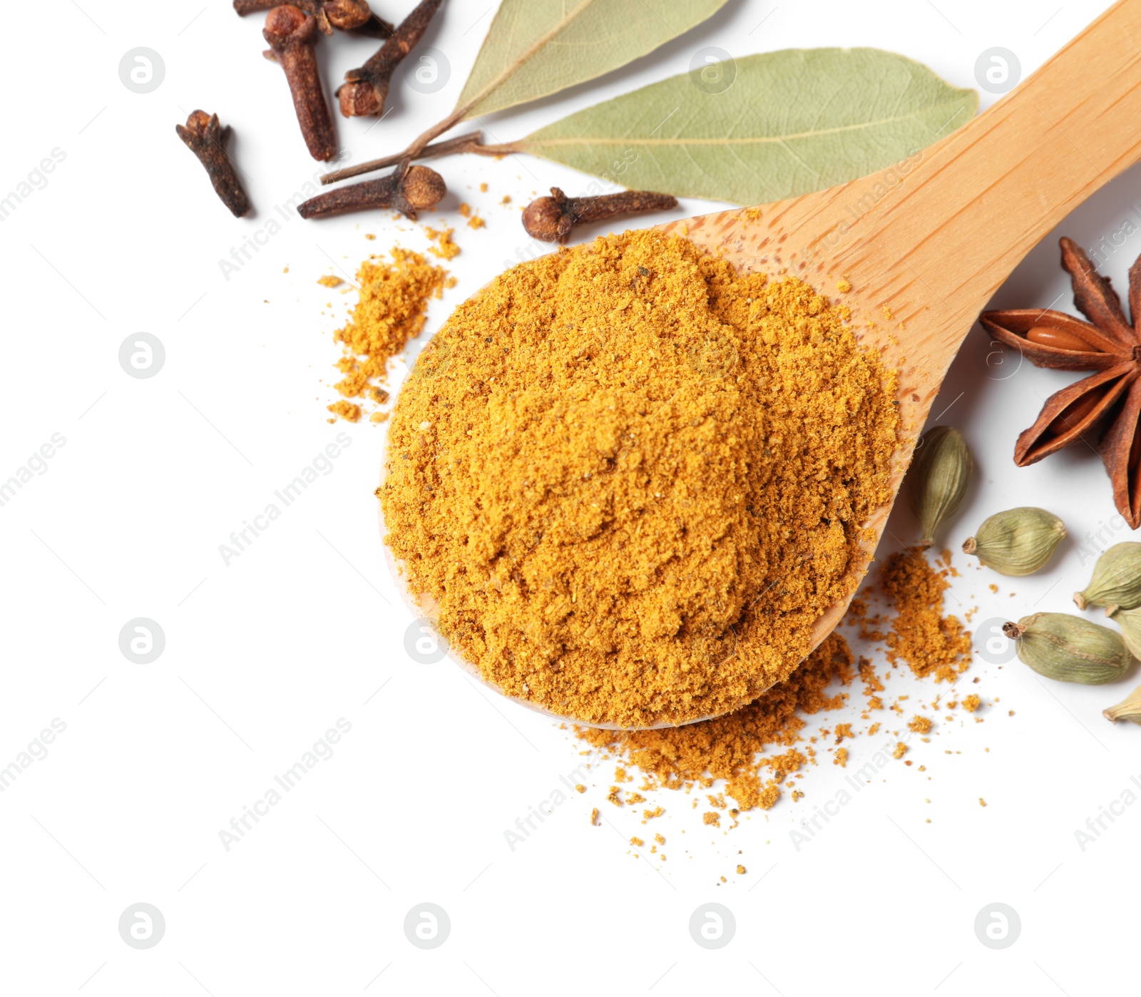 Photo of Spoon with dry curry powder and other spices isolated on white, top view