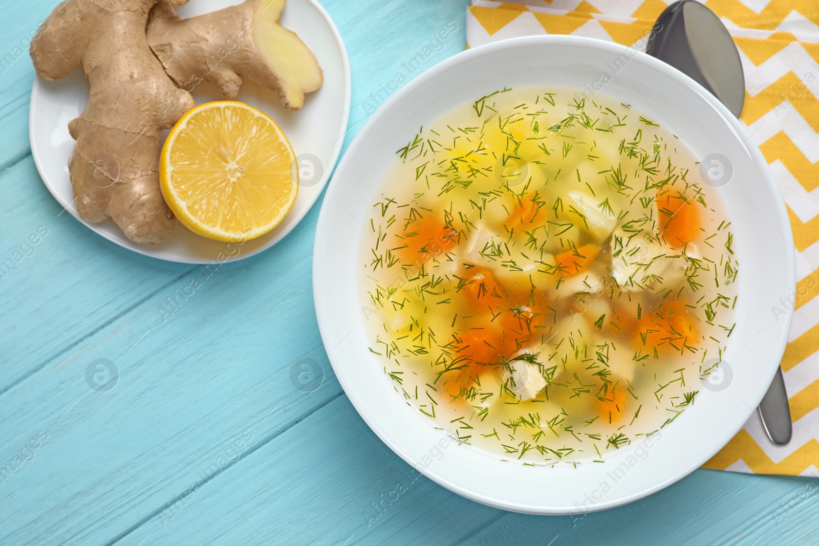 Photo of Flat lay composition with bowl of fresh homemade soup to cure flu on wooden background