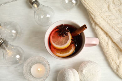 Photo of Flat lay composition with cup of hot winter drink on wooden background. Cozy season