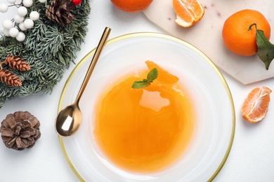 Photo of Delicious tangerine jelly on white table, flat lay