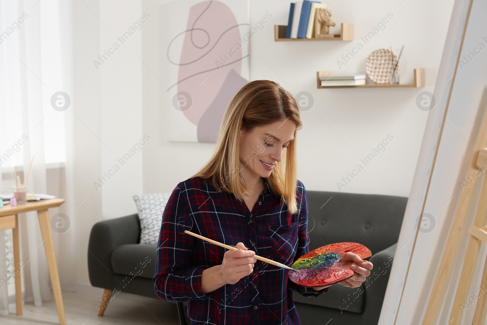 Photo of Beautiful woman painting in studio. Creative hobby