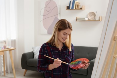 Beautiful woman painting in studio. Creative hobby