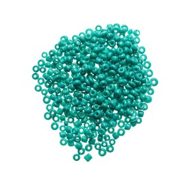 Pile of turquoise beads on white background, top view