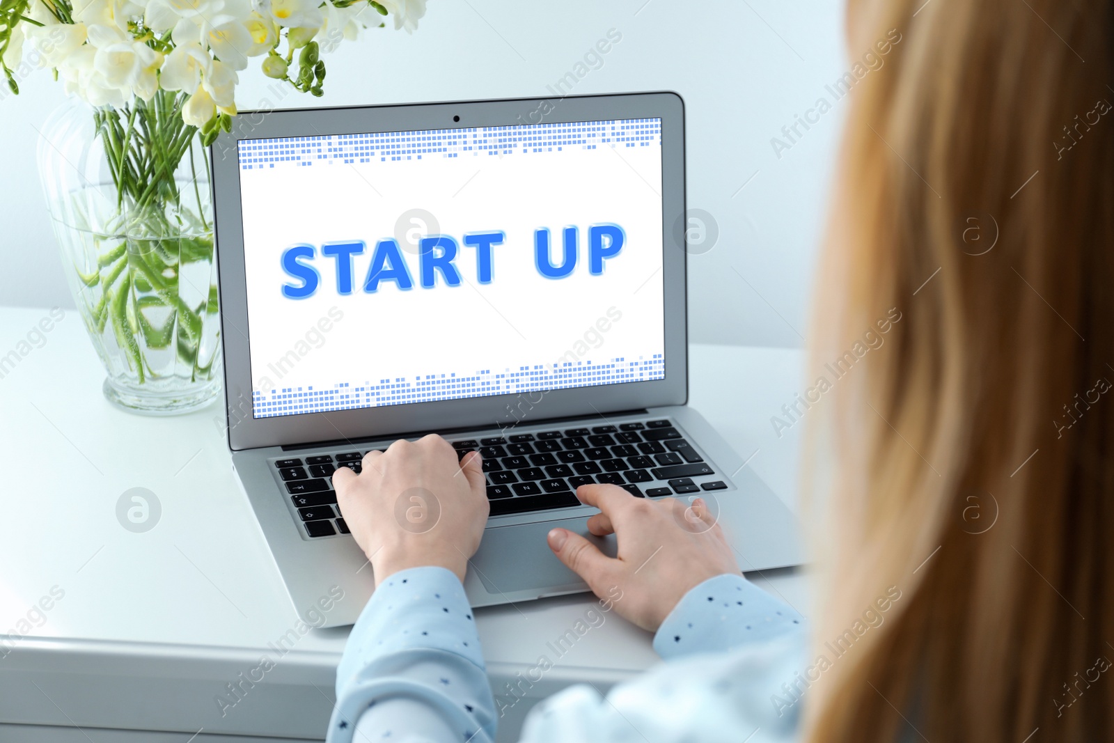 Image of Woman working on modern laptop at white table indoors, closeup. Startup idea