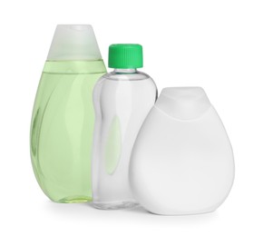 Photo of Bottles with baby oil, shampoo and gel isolated on white