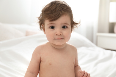 Photo of Adorable little baby on bed. Cute child