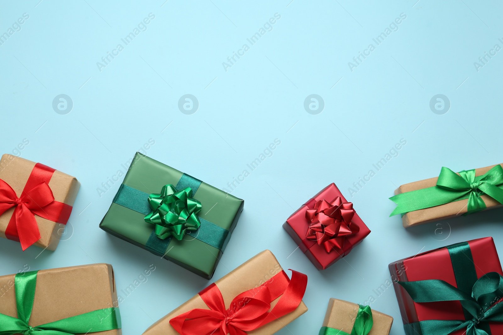 Photo of Many gift boxes on light blue background, flat lay. Space for text