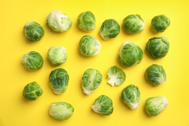 Fresh Brussels sprouts on yellow background, flat lay