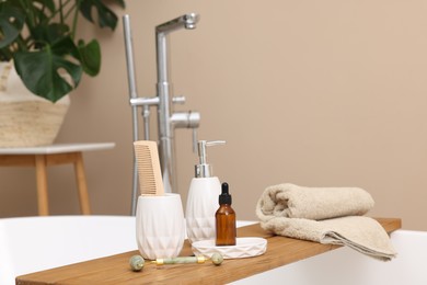 Different personal care products and accessories on bath tub in bathroom